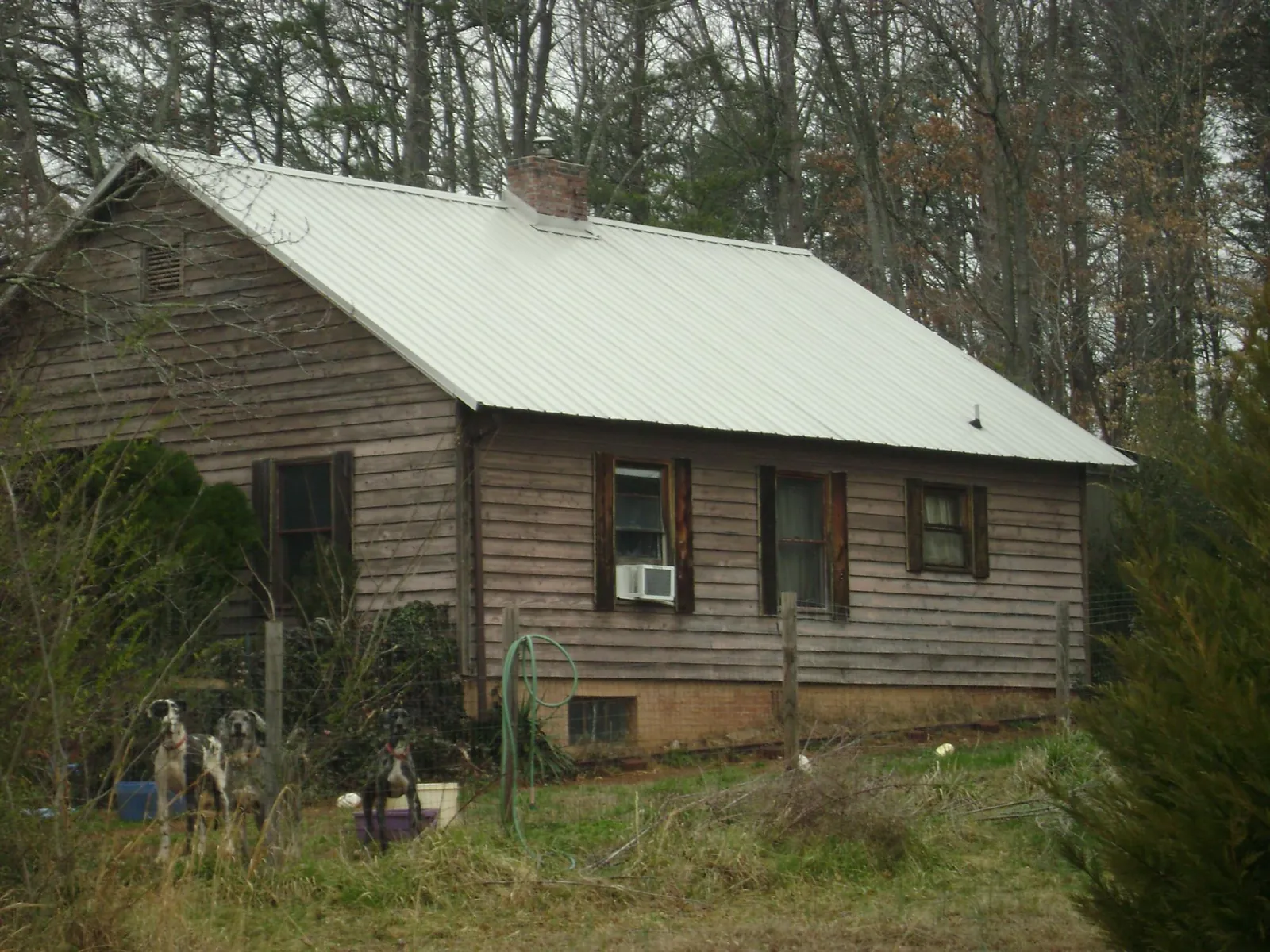 White metal roof on an old wood sided farmhouse, from a Asphalt Shingle Roof Repair job in Cranford